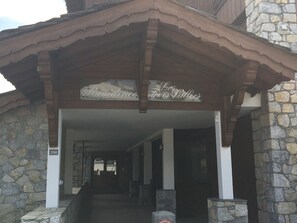 Enter Les Trois Valles through the stone pillars and into the welcoming doorway.