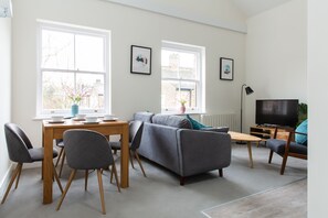 42-inch Smart TV with cable channels, Netflix, streaming services - Queens Park by Viridian Apartments (London)
