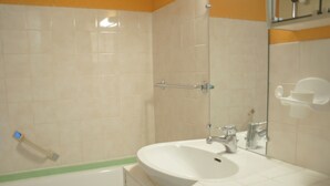 A bathroom with a white sink, a mirror, and a bathtub. - Mountain Studio with Wifi 100m from Pra Loup 1600 Slopes (Pra-Loup)
