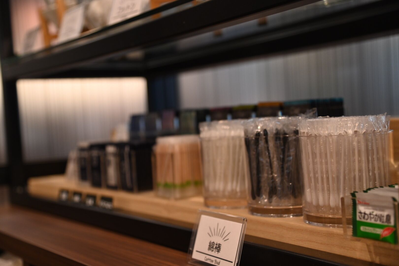 A shelf with various packaged goods, including jars and containers, likely in a store or market setting.
