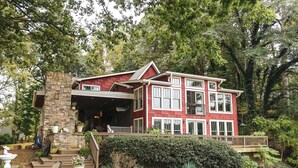 A two-story house with a stone facade, large windows, and a covered front porch. - Beautiful Charlotte Lake Wylie Waterfront Bungalow (Charlotte)