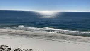 A beach with a clear sky and calm sea. - Direct Gulf front, sea breeze! - 3BR/3BA - Lighthouse 1115 - Spectacular views!  (Gulf Shores)