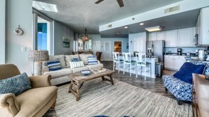 A spacious living area with a sofa, coffee table, and a ceiling fan. - Direct Gulf front, sea breeze! - 3BR/3BA - Lighthouse 1115 - Spectacular views!  (Gulf Shores)