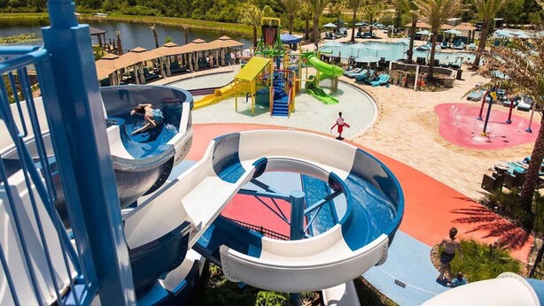 A water park with multiple water slides, a pool area, and a beach. - 172 Balmoral (Haines City)