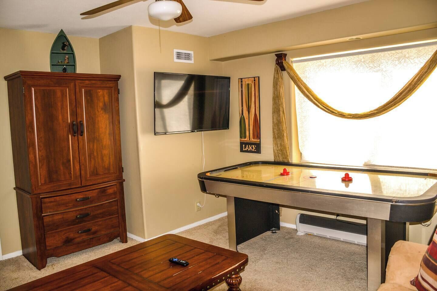 Fun game room with air hockey, TV, and cozy lounge vibes