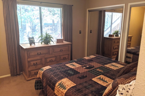 Cozy rustic bedroom with natural light and mirrored closet