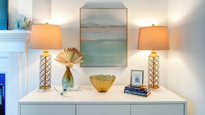 A white console table with two lamps, a vase, a bowl, and a framed picture. - Walk to restaurants! 10min to beaches and downtown Charleston.  (Mount Pleasant)