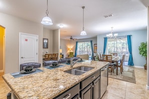 Enjoy meals in the dining area with a table and chairs, and relax in the adjacent living room with a sofa and coffee table.
