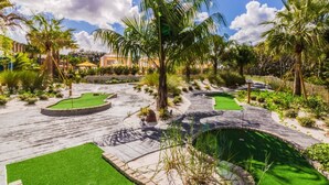 A landscaped garden with palm trees, a fountain, and a gazebo. - Festival by PRP (Davenport)