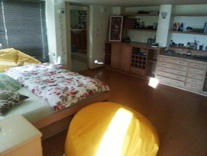 Cozy retreat with a single bed, floral-patterned bedspread, and a compact wardrobe.