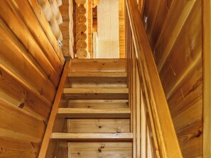 A wooden staircase with a handrail, leading upwards. - Tunturimaja 2 mökki by Interhome (Hyrynsalmi)