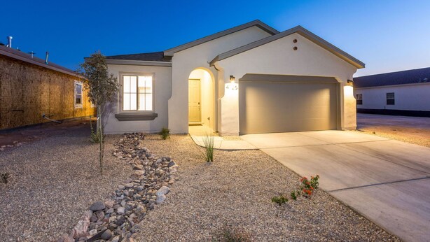 A modern two-story house with a garage, a well-maintained gravel driveway, and a small garden area. - Relaxing Oasis Near White Sands National Monument (Las Cruces)