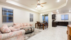 A spacious living room with a sofa, coffee table, and dining area. - Relaxing Oasis Near White Sands National Monument (Las Cruces)