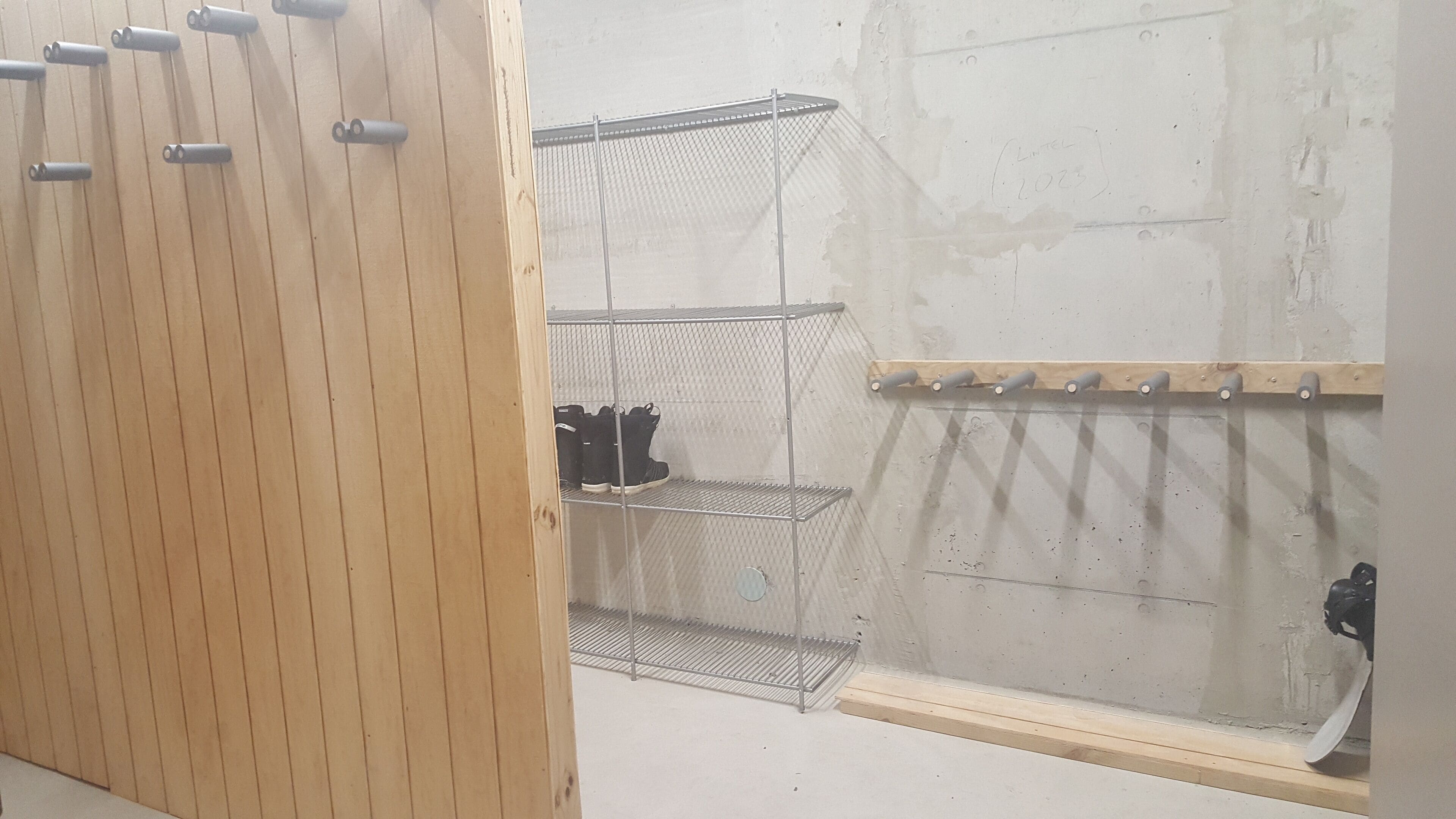 A storage area with metal shelves and wooden cabinets.