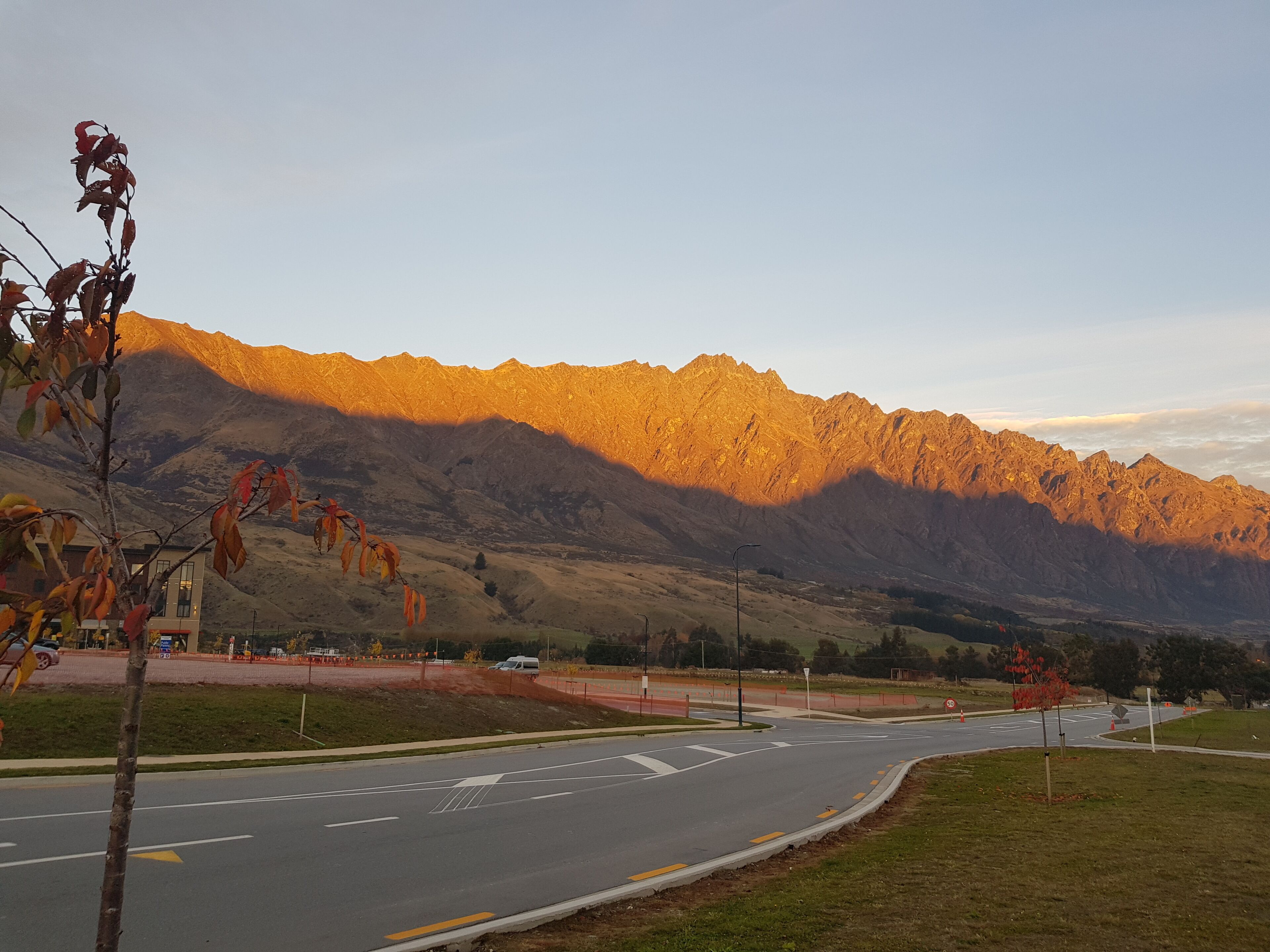 A road with a mountain range in the background.