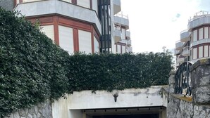 A stone-walled entrance to a building with a paved pathway leading to a dark interior. - Beach apartment with stunning views (Noja)