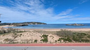 A coastal road with a beach and dunes in the background. - Beach apartment with stunning views (Noja)