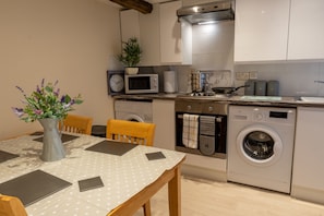 Microwave, oven, toaster, dining tables