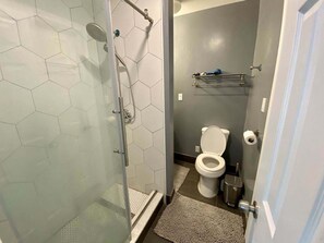 Shower, hair dryer, towels, toilet paper
