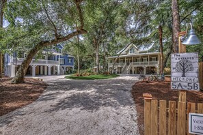 A gated entrance to a residential area with a sign indicating 'The Cottages of Hickory 5A-5B'.