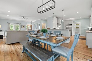 A modern kitchen with a dining area, wooden flooring, and a ceiling fan. - Seabrook Village! Amenity access available for purchase!! Pet Friendly! (Seabrook Island)