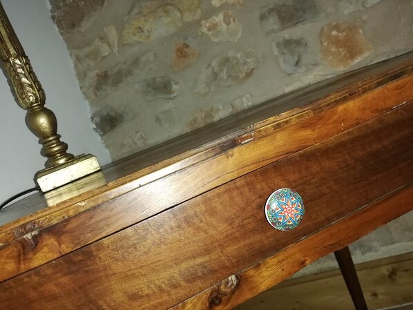 Una mesa de madera con un remate de latón y un objeto circular decorativo.