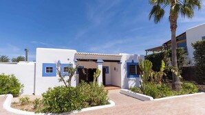 A white building with blue accents and a covered entrance.