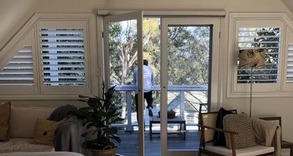 BIRDSONG <br>Stylish private couples loft with water glimpses through the treetops.