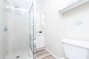 Shower, hair dryer, towels, toilet paper