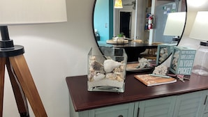 A wooden desk with a glass terrarium, keys, a notebook, and a decorative sign. - AWESOME VIEW... On Private Gulf of Mexico Beach... Majestic Views  🐢🌴🌞 (Alligator Point)
