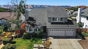 A two-story house with a garage, surrounded by a well-maintained lawn and trees. - 2800sqft Luxurious home with bay view private pool near SF & NAPA (Vallejo)