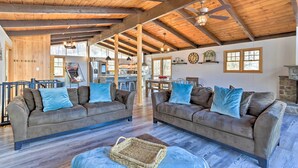 A spacious living area with two sofas, a coffee table, and a ceiling fan. - Lake Escape In the Poconos (Pocono Lake)