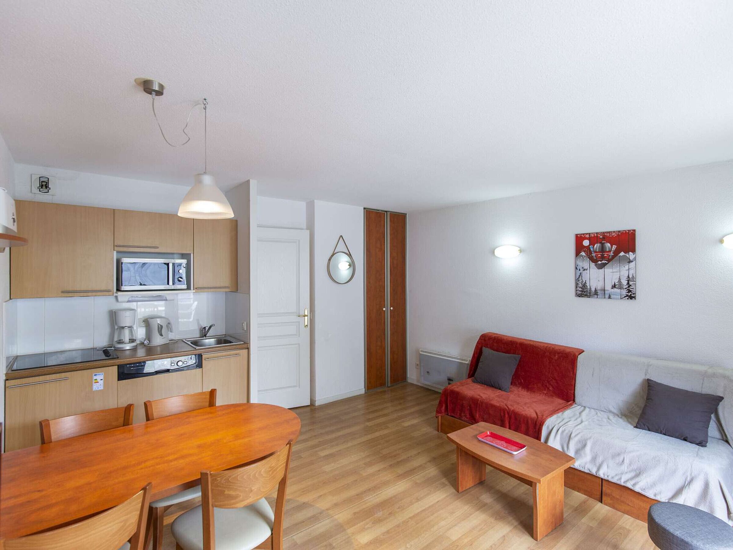 A compact living space with a kitchen, dining area, and seating area.