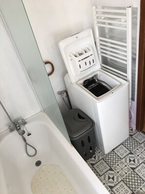 Bathtub, hair dryer, toilet paper