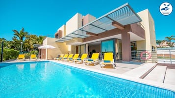 A heated pool, pool loungers