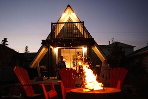 A triangular building with a glass facade and a fire feature in the center. - Cozy A-frame cabin 1/2 block from the gorgeous Sylvan Lake beach, parks & pubs (Sylvan Lake)