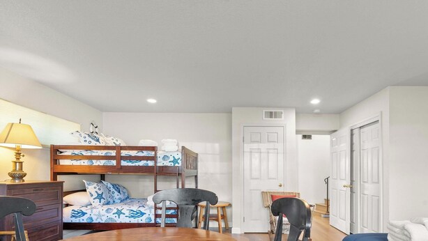 A room with bunk beds, a desk, a chair, and a lamp. - Bay Watch Beach House (Santa Cruz)