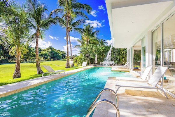 Private pool surrounded by tropical greenery.