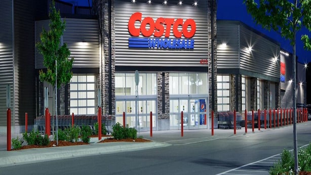 A Costco Wholesale store at night with a clear view of the entrance and signage. - 3 Beds 2 Baths by Costco, GP Airport, Restaurants (Grande Prairie)