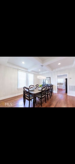Enjoy meals in this dining area with a long table and six chairs.