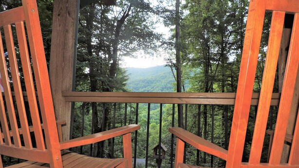 Two wooden chairs on a wooden deck with a view of a forest and mountains. - Cozy cabin, Babbling Brook & Mountain View w/fast Wi-Fi (Robbinsville)