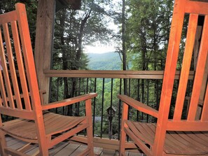 Two wooden chairs on a wooden deck with a view of a forest and mountains. - Cozy cabin, Babbling Brook & Mountain View w/fast Wi-Fi (Robbinsville)