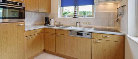 Fridge, stovetop, dishwasher, coffee/tea maker