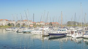 A marina with numerous boats docked, a clear sky, and buildings in the background. - 4 bedroom gorgeous home in Wemeldinge (Wemeldinge)
