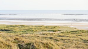 A coastal landscape with a beach and grassy dunes. - 4 bedroom pet friendly home in Portbail (Portbail)