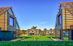 A modern building with a sloped roof and a central courtyard.