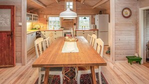 A wooden dining table with chairs, a white pendant light, and a patterned runner. - 4 bedroom awesome home in Sykkylven (Sykkylven)