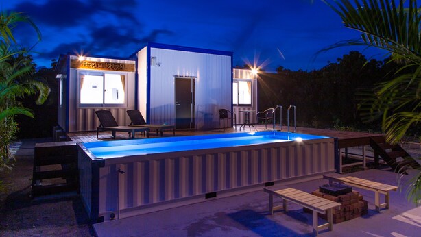 A modern house with a swimming pool, outdoor seating, and a sign that reads "Regina Ishigaki". - Regina Ishigaki Blue Stage (Ishigaki)