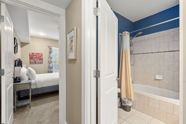 A bathroom with a bathtub, shower, and toilet. - 2 King Beds, Outdoor Fireplace and Air Hockey (Canton)