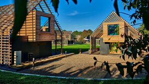 Une structure moderne en bois, dotée d’un toit en pente et d’une petite fenêtre.
